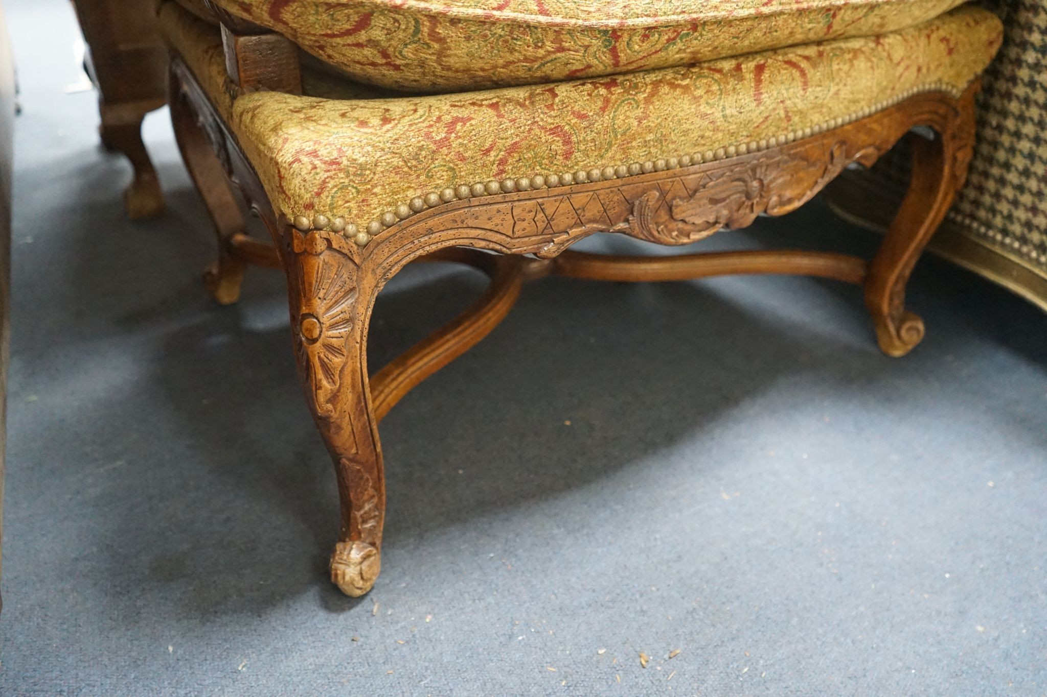 An 18th century style French walnut upholstered open armchair, width 68cm, depth 60cm, height 108cm